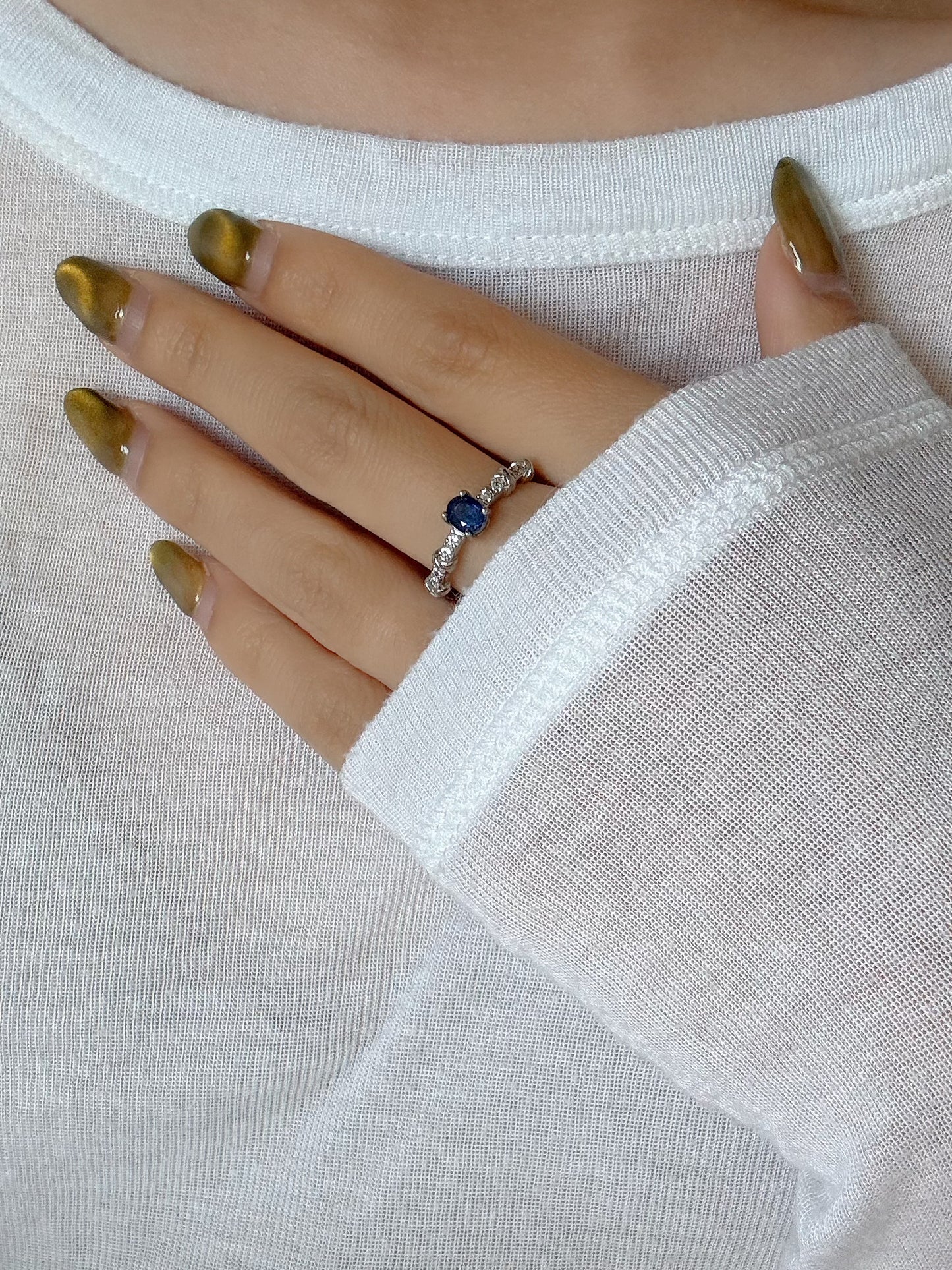 model wearing blue sapphire silver ring