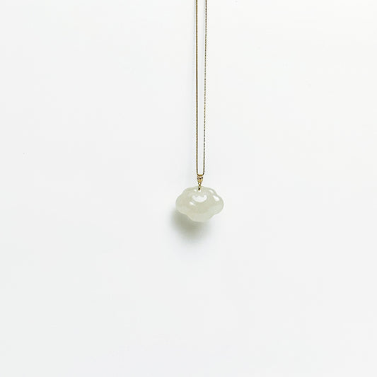 A side look of the Lucky Cloud White Jade Necklace featuring a soft white jade pendant with 18k gold bail and gold-plated 925 silver chain, in a refined minimalist design.