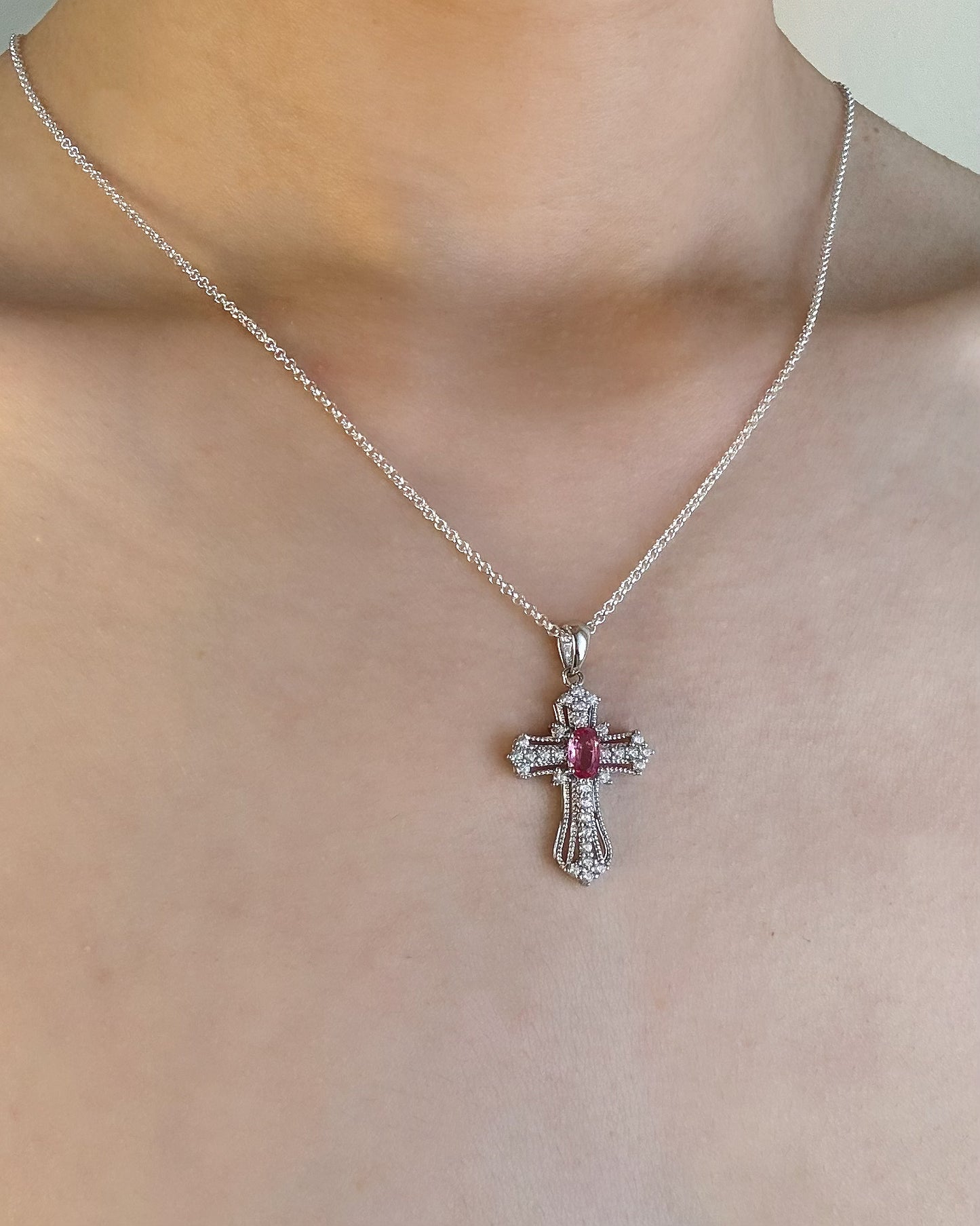 Natural Pink Sapphire Cross silver necklace with cubic zirconia model look. Modern fine jewelry.