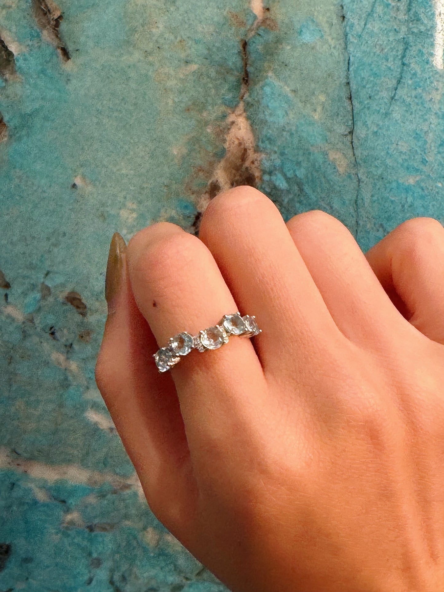 aquamarine silver band blue background close look