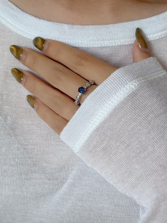 model wearing blue sapphire silver ring