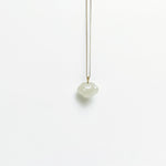 A side look of the Lucky Cloud White Jade Necklace featuring a soft white jade pendant with 18k gold bail and gold-plated 925 silver chain, in a refined minimalist design.