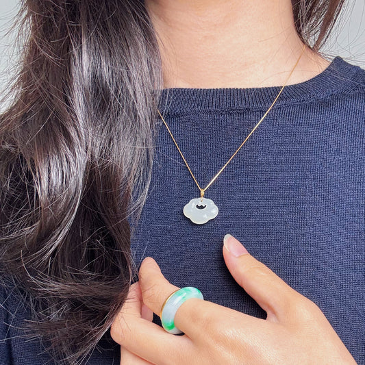 Model wearing Lucky Cloud White Jade Necklace with a navy blue top, showcasing a classic yet casual style with soft jade and gold accents.