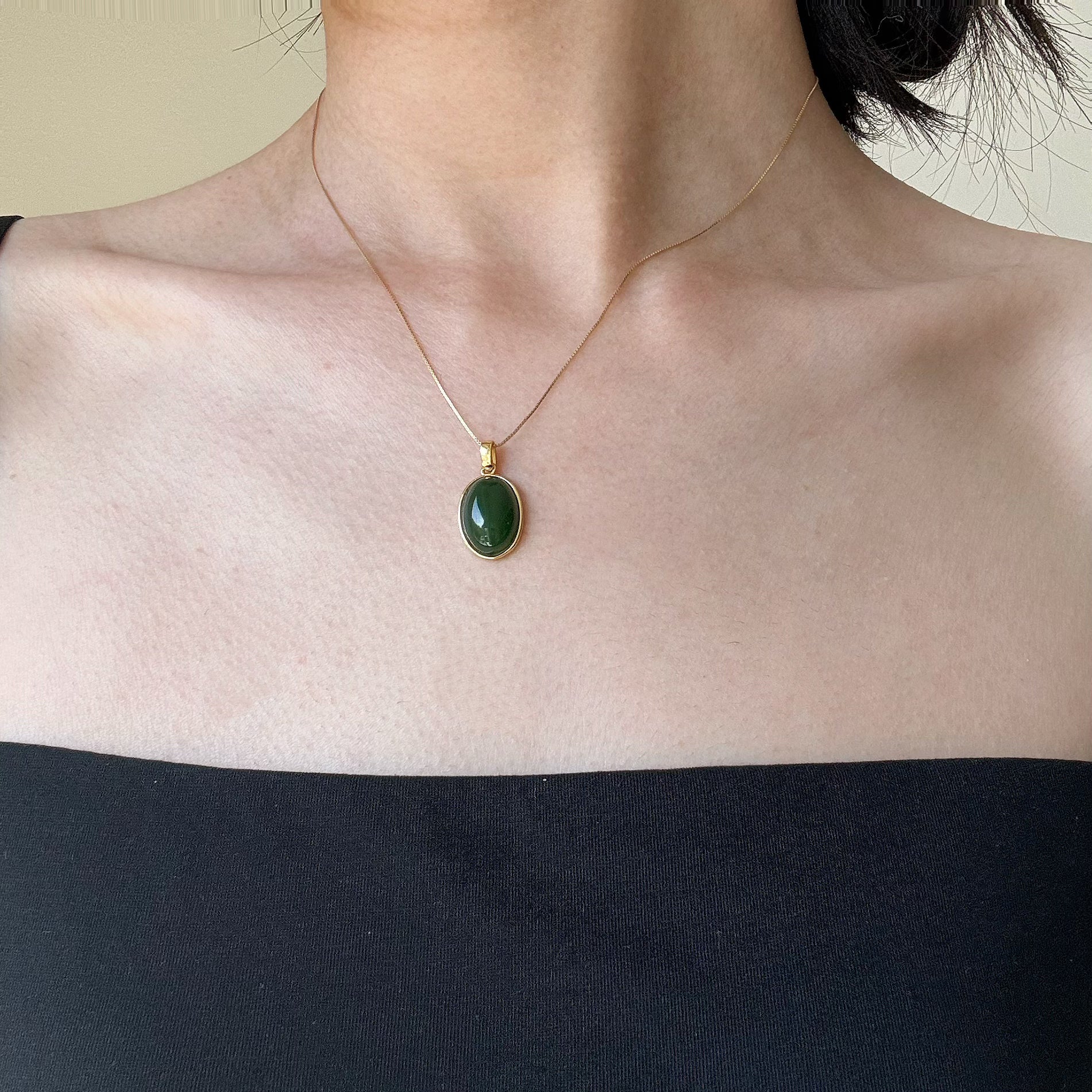 Model wearing the Oval Green Jade Necklace, showcasing its timeless elegance and classic style with a gold-plated 925 silver chain.