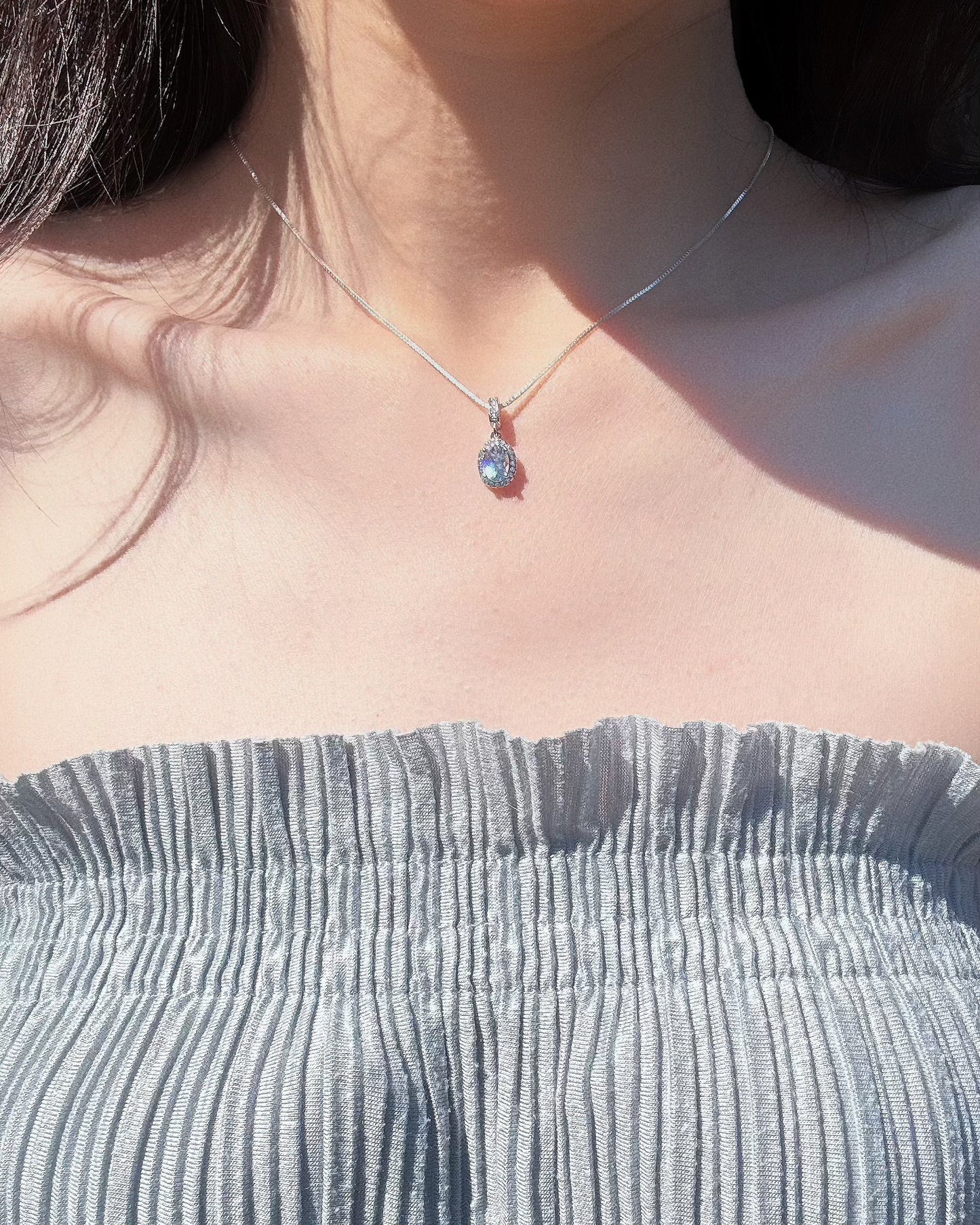 model wearing aquamarine ocean whisper necklace. front look