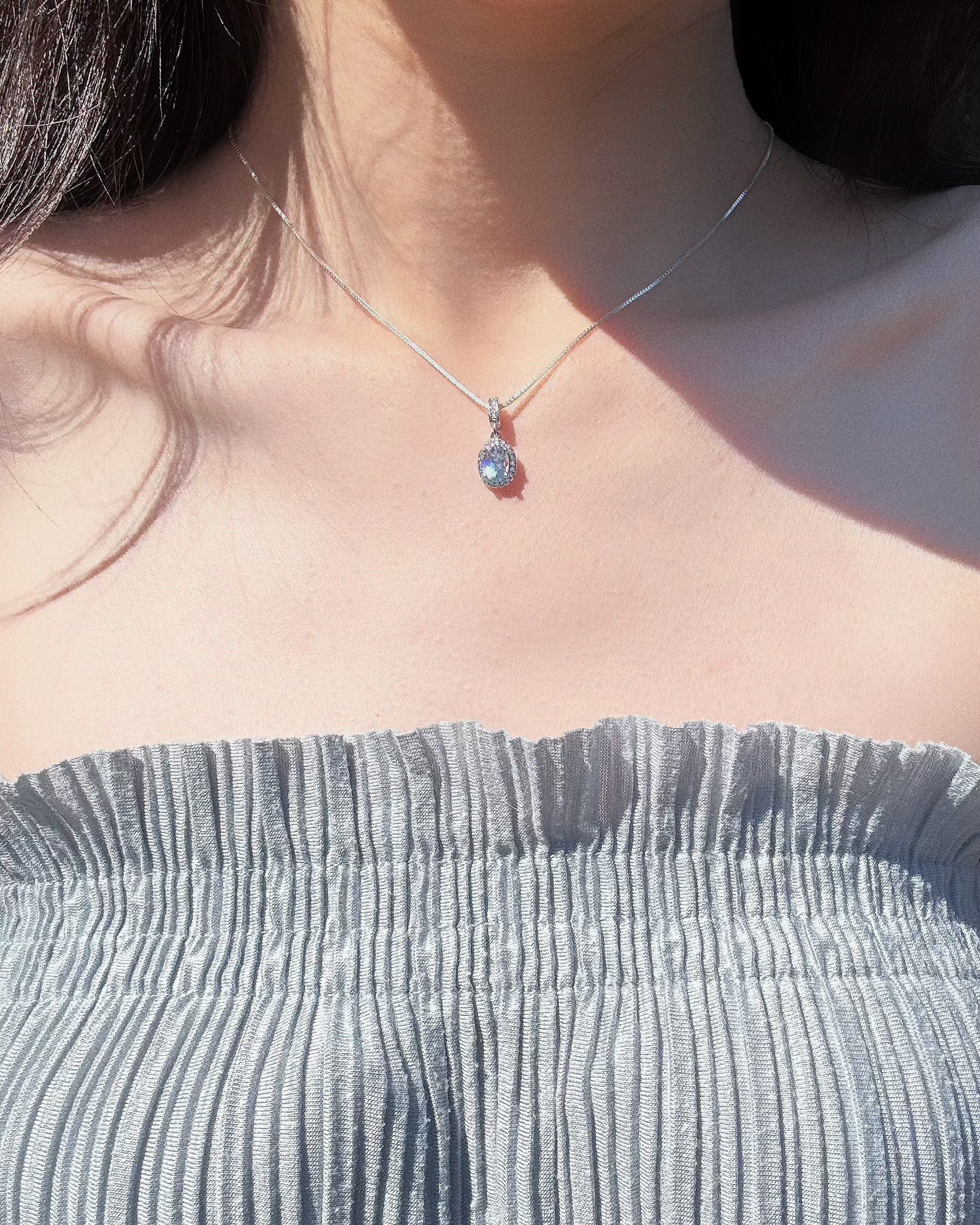 model wearing aquamarine ocean whisper necklace. front look