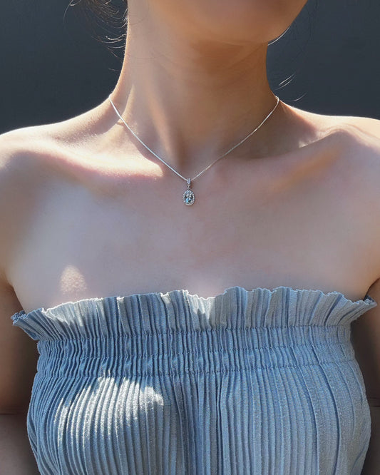 Person wearing aquamarine ocean whisper silver necklace
