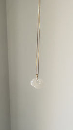 Lucky Cloud White Jade Necklace showing a soft, natural glow in sunlight, highlighting the serene beauty of white jade and gold-plated silver.