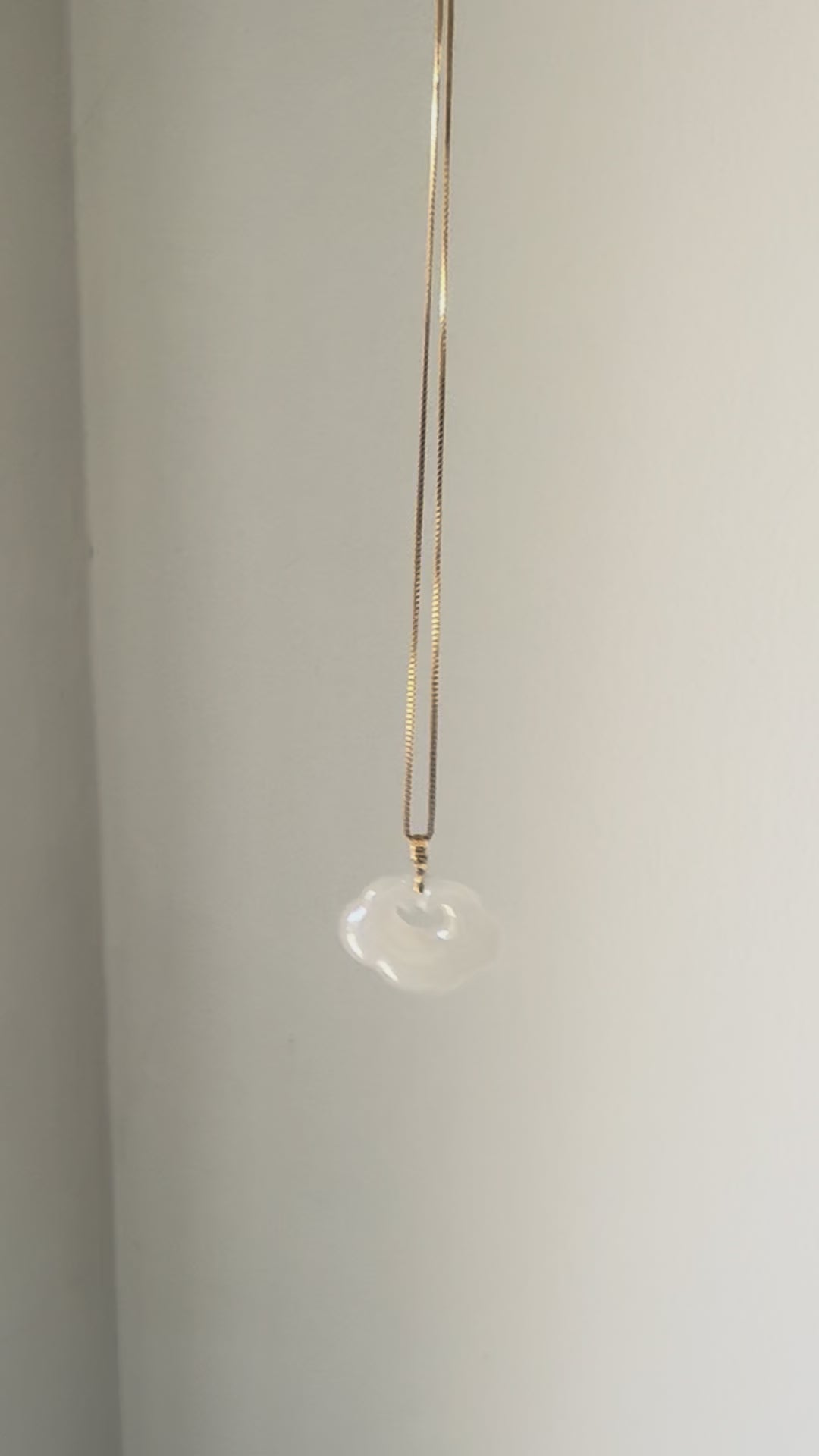 Lucky Cloud White Jade Necklace showing a soft, natural glow in sunlight, highlighting the serene beauty of white jade and gold-plated silver.