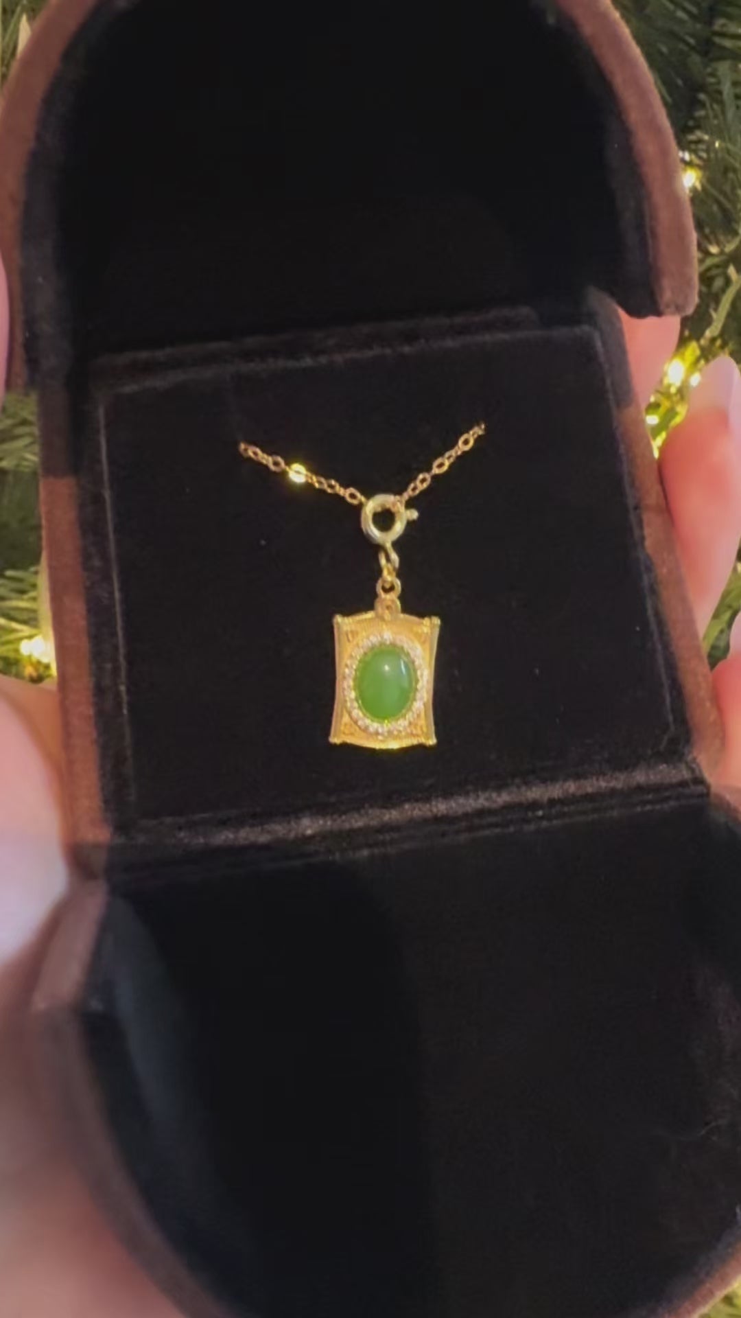 oval jade frame silver necklace shines under the light